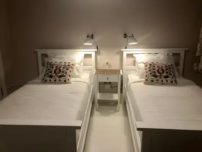 two beds in a small room with white walls at Mehmet Bey Suites in Istanbul