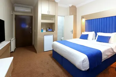 a hotel room with a large bed and a television at Taksim ABC Hotel in Istanbul