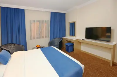 a hotel room with a bed and a flat screen tv at Taksim ABC Hotel in Istanbul