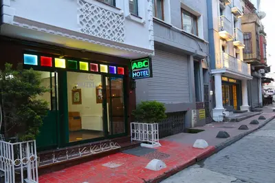 a store front with a neon sign on a street at Taksim ABC Hotel in Istanbul