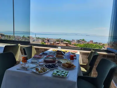 a table with food and a view of the ocean at City Hall Hotel Sultanahmet in Istanbul