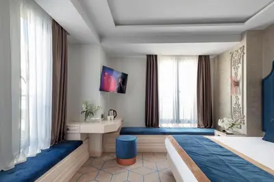 a hotel room with two beds and a sink at Danis Hotel & Spa Istanbul - Old City in Istanbul
