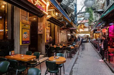 an empty street with tables and chairs in a restaurant at Sanat Hostel Taksim in Istanbul