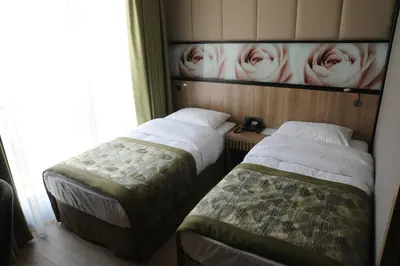 a room with two beds and a picture of roses at RADAR HOTEL in Istanbul