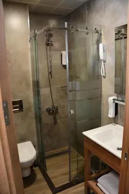 a bathroom with a shower with a toilet and a sink at RADAR HOTEL in Istanbul