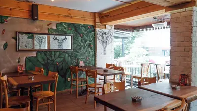 a restaurant with wooden tables and chairs in a room at Barkod Otel in Istanbul
