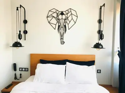 a bedroom with a bed with two lights above it at Barkod Otel in Istanbul