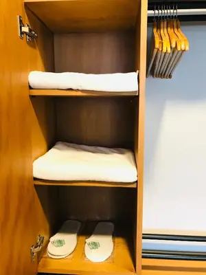 a cupboard with two toilets and towels in it at Barkod Otel in Istanbul