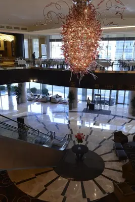 a large lobby with a chandelier in a building at Wyndham Grand Istanbul Europe in Istanbul