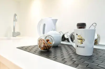 a counter with two coffee cups and nuts on it at Stay Lab Taksim 15 Suites in Istanbul