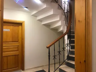 a staircase in a house with a wooden door at Green Mansion in Istanbul