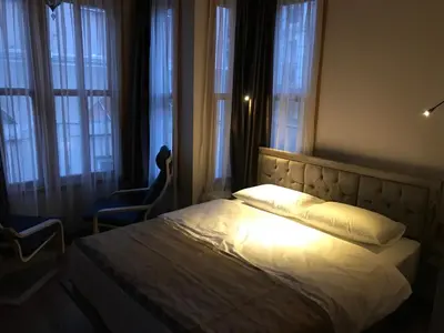 a bedroom with a bed with a light on it at Green Mansion in Istanbul