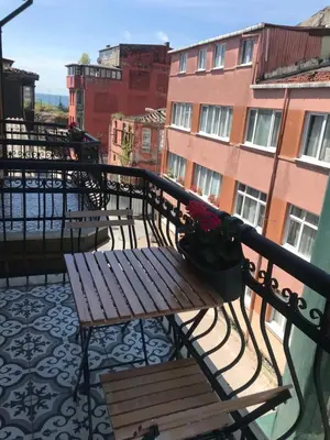 a balcony with a bench on a balcony with buildings at Green Mansion in Istanbul