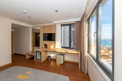 a hotel room with a desk and large windows at Yez Boutique Hotel in Istanbul