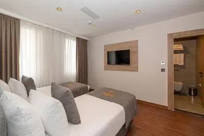 a hotel room with two beds and a television at Yez Boutique Hotel in Istanbul