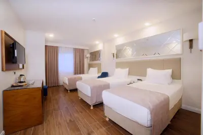 a hotel room with two beds and a television at SORRISO HOTEL DUE in Istanbul