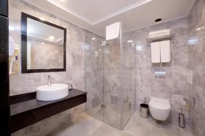 a bathroom with a sink and a shower and a toilet at SORRISO HOTEL DUE in Istanbul