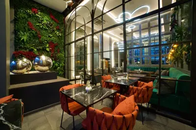 a restaurant with tables and chairs and a large window at SORRISO HOTEL DUE in Istanbul