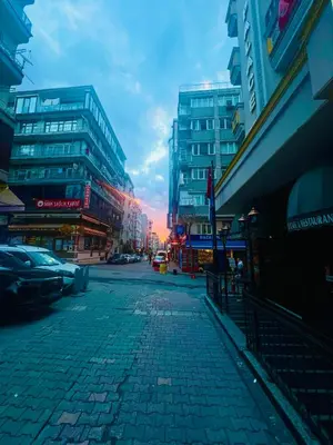 a city street with tall buildings and a sunset at Elit Palace Hotel in Istanbul