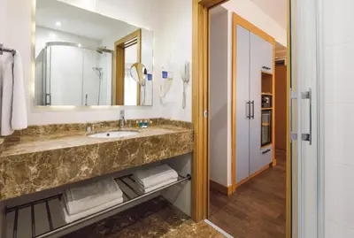 a bathroom with a sink and a mirror at Urban Hotel Bomonti in Istanbul