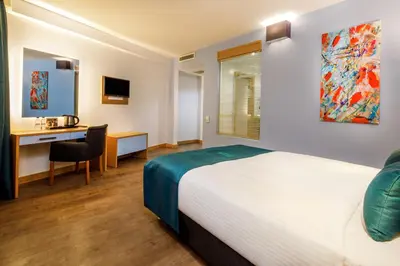 a bedroom with a bed and a desk with a computer at Urban Hotel Bomonti in Istanbul