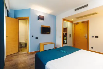 a bedroom with a large bed and a bathroom at Urban Hotel Bomonti in Istanbul
