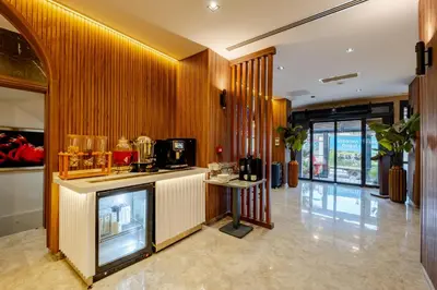 a hotel lobby with a counter and a kitchen at Frt Airlines Hotel - Istanbul Airport in Arnavutköy