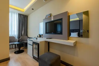 a hotel room with a television and a living room at Frt Airlines Hotel - Istanbul Airport in Arnavutköy