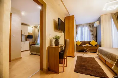 a hotel room with a bed and a desk in it at Kavalalı Suites in Istanbul