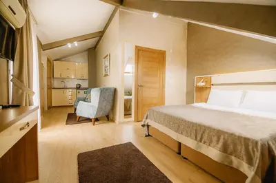 a bedroom with a bed and a chair in a room at Kavalalı Suites in Istanbul