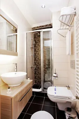 a bathroom with a sink and a toilet and a shower at Kavalalı Suites in Istanbul