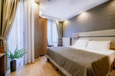 a hotel room with a bed and a window at Kavalalı Suites in Istanbul