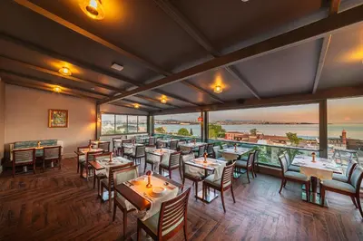 a restaurant with tables and chairs and large windows at Azade Premier Hotel in Istanbul