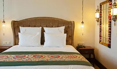 a bedroom with a bed with white pillows at Azade Premier Hotel in Istanbul