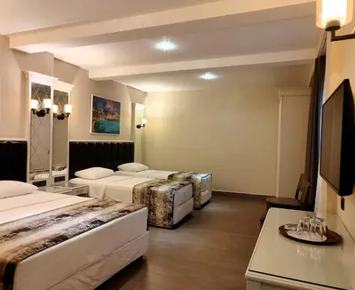 a hotel room with two beds and a table at Morava Hotel in Istanbul