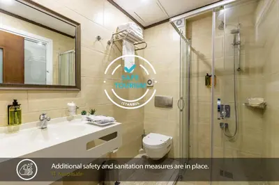 a bathroom with a shower and a sink and a toilet at MENAR HOTEL&SUITES -Old City Sultanahmet in Istanbul