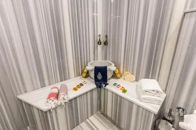 a bathroom with a table with towels on it at MENAR HOTEL&SUITES -Old City Sultanahmet in Istanbul