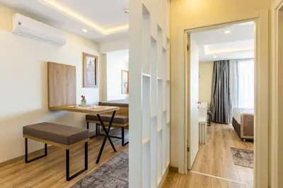 a room with a table and a room with a bed at MENAR HOTEL&SUITES -Old City Sultanahmet in Istanbul