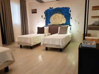 a room with two beds and a painting on the wall at Rumours Inn in Istanbul