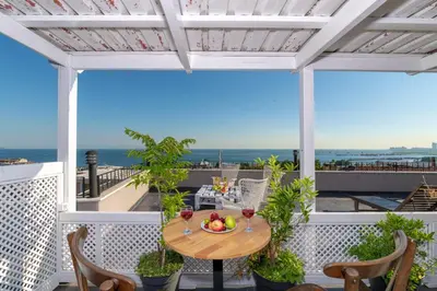 a table on a balcony with a view of the ocean at Rumours Inn in Istanbul