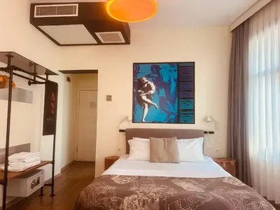 a bedroom with a bed and a painting on the wall at Rumours Inn in Istanbul