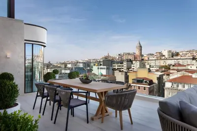 a table and chairs on a balcony with a view at JW Marriott Istanbul Bosphorus in Istanbul