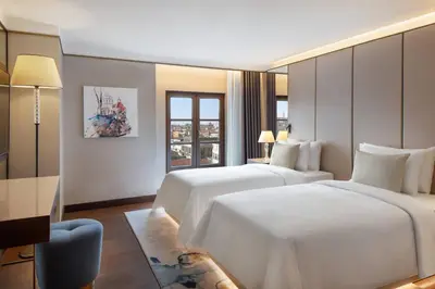a hotel room with two beds and a desk at JW Marriott Istanbul Bosphorus in Istanbul