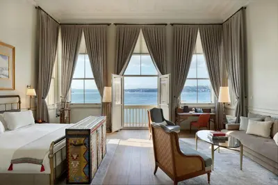 a bedroom with a bed and a living room at Kocatas Mansions in Istanbul