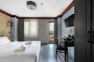 a hotel room with a bed and a desk with a view at Mytra Hotel in Istanbul