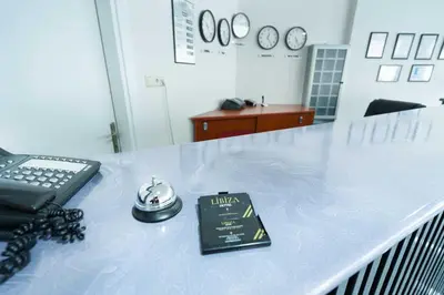 a table with a phone and a sign on it at Hotel Libiza in Gebze