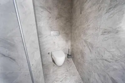 a bathroom with a toilet in a shower stall at Hotel Libiza in Gebze