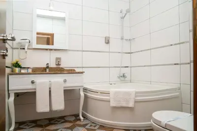 a bathroom with a tub and a sink and a toilet at Mugwort Hotel & Spa in Istanbul