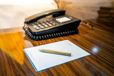 a cell phone and a pencil on a table at Mugwort Hotel & Spa in Istanbul
