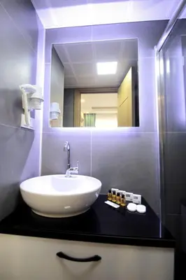 a bathroom with a sink and a mirror at Hira Hotel in Istanbul